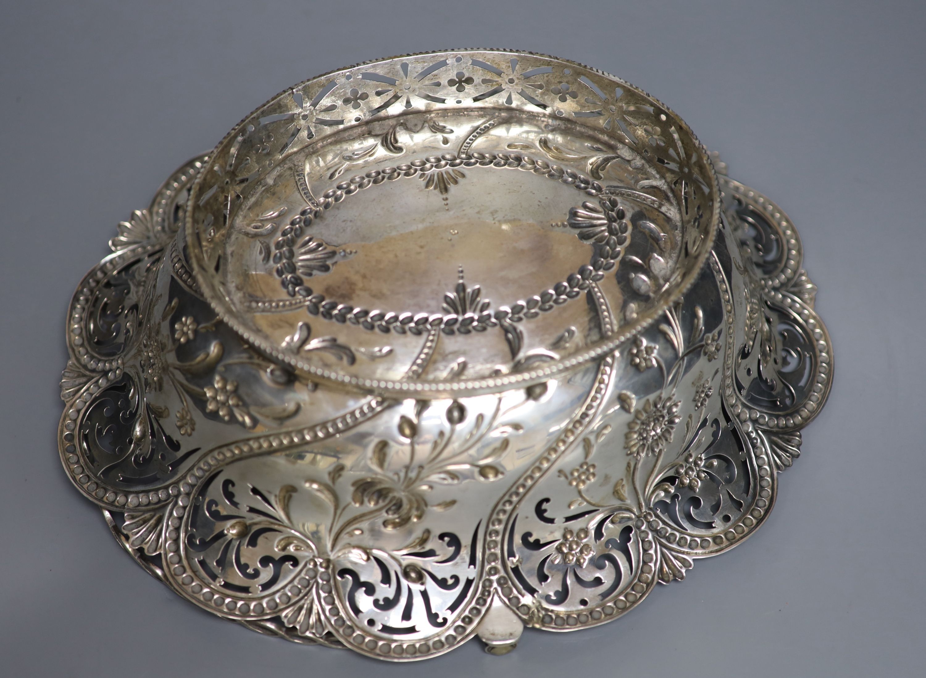 An early George III silver basket, with later? pierced and embossed decoration, Richard Meach, London, 1768, length 30.8cm, 21oz.